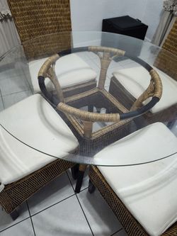 Four chairs with glass round table