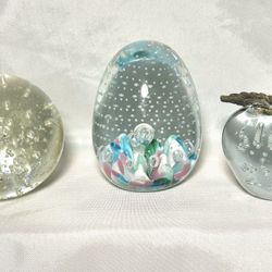 3 glass paperweights controlled bubbles.  apple 3”tall. Egg shaped 4”tall Round heavy glass 3”