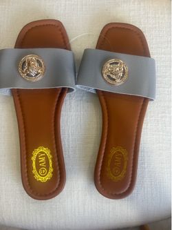 Women’s Gray Flat Slide Sandals with Gold Medallion Accent