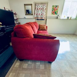 Red Couch with two pillows 