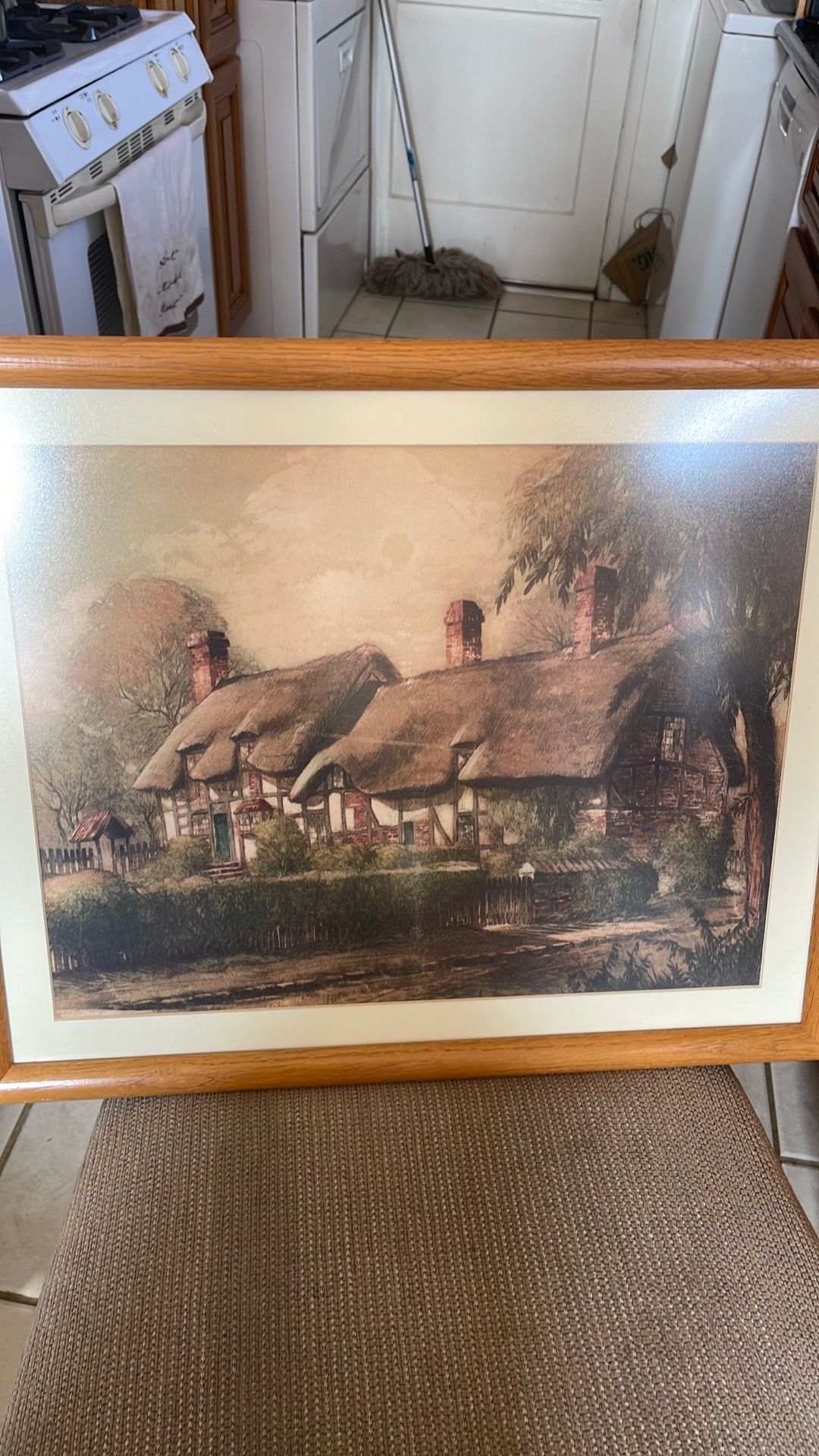 Framed pictures of a cottage, a mill and a house