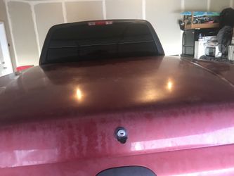 Tonneau cover off of a red 2001 Ford F-150.