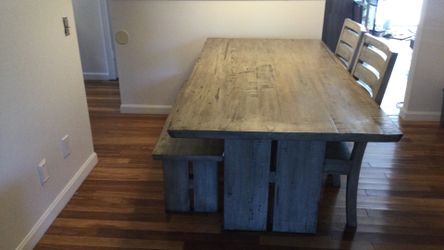 Farm style weather grey kitchen table with two chairs and bench