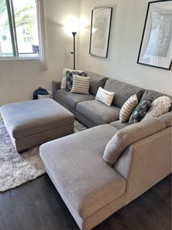Grey Costco sectional couch with ottoman