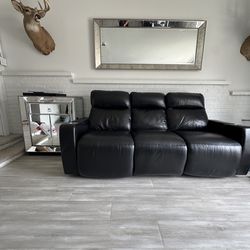 Leather couch reclines.