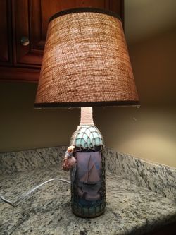 Nautical light lamp from wine bottle with netting seashells and sailboat picture