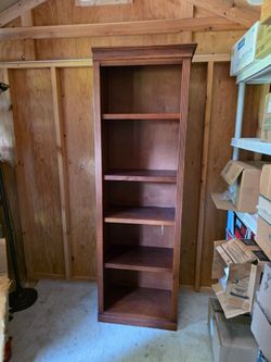 Tall, narrow solid wood bookcase