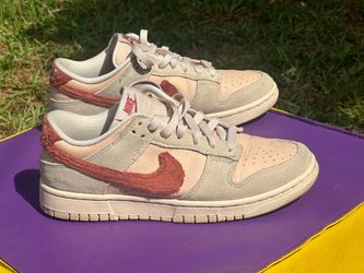Nike Dunk Low "Terry Swoosh" sneakers, recognizable by their plush, textured swoosh logos.