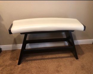 Curved Bench featuring a dark brown wood base and a white upholstered seat