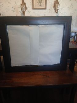 34 1/2" L. by 28" W. Dark wood frame mirror