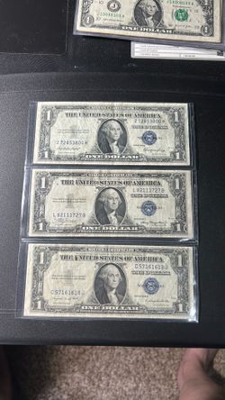 Three crisp 1935 one dollar bills