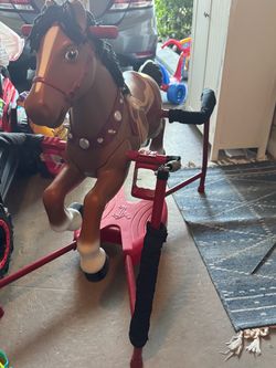 Flexible Flyer/Reno Flyer-style spring horse, with the metal frame, springs, plastic molded horse, saddle, and foot platform.