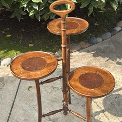 Vintage cherry wood pastry or plant stand can also be used as a side table.