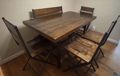 Rustic wood and metal counter height dinning set with a bench seat and 4 chairs