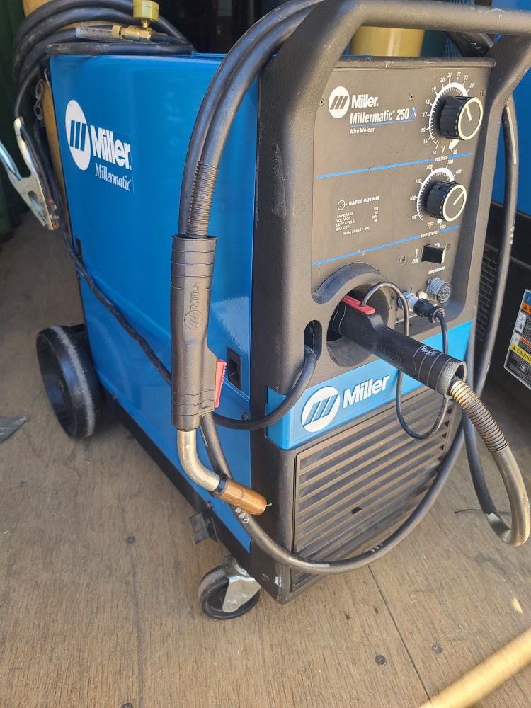 Miller Millermatic 250X mig welder like new, can come with spoolgun and two large tanks