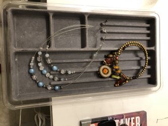 Jewelry organizer for a drawer and two beaded necklaces