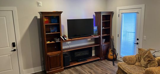 Massoud couch and oversized chair. All wood entertainment center fireplace and possible soundbar and woofer.