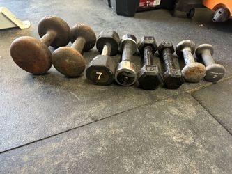 Cast iron and rubber-coated dumbbell set includes a variety of weights. The collection consists of two 2lb Reebok dumbbells, one 3lb hex dumbbell, one