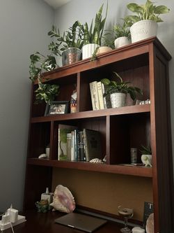 Large dark wood desk with drawers and shelves