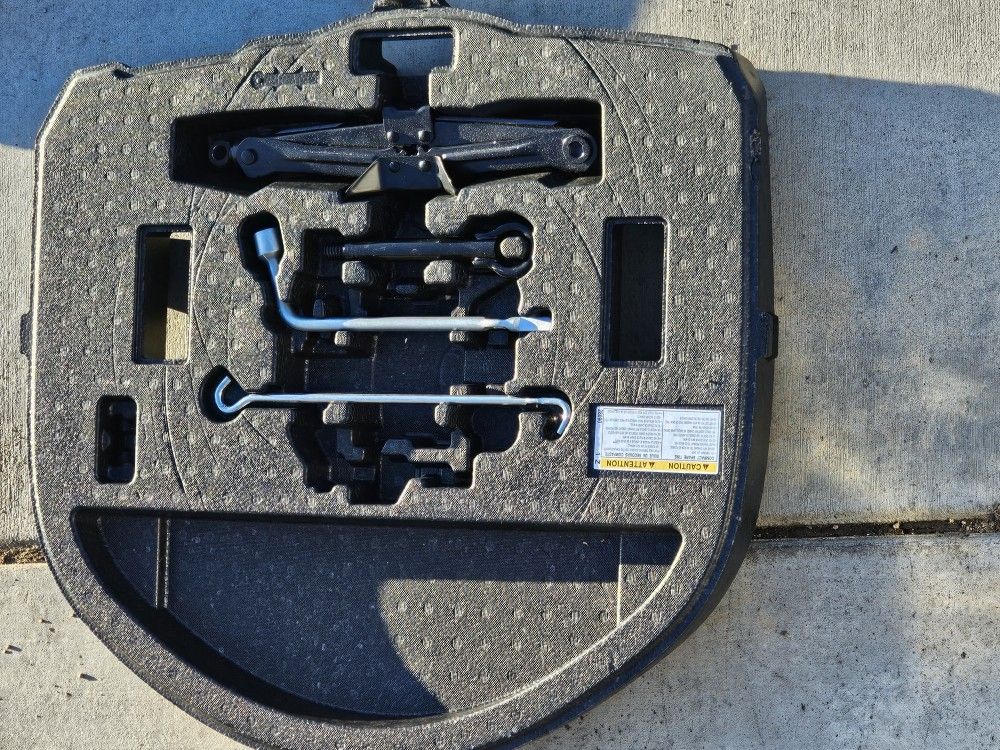 Toyota Corolla Hybrid Sedan Spare tire setup. And roof racks.