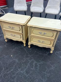 vintage French Provincial or French Country style two-drawer nightstands in a soft cream finish
