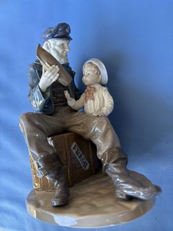 Lladro Man and boy holding toy boat