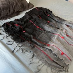 Scarf Wrap Avant Garde Ombre Style Black  with Red Knots Hanging Balls Fringe.  64” length x 20” width Has stretch weave material  Comes from a pet an