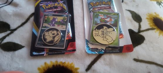 Pokemon cards and coins mega evolution a the other is scarlet and violets journey
