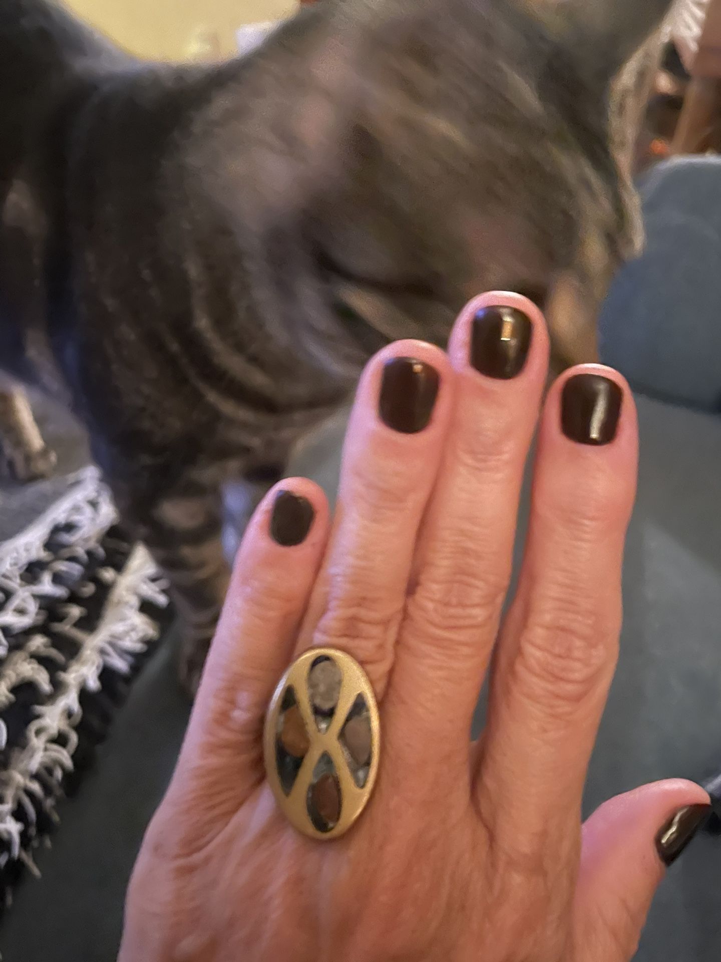 Modernistic oval-shaped face inlaid with fused dichroic glass in brass