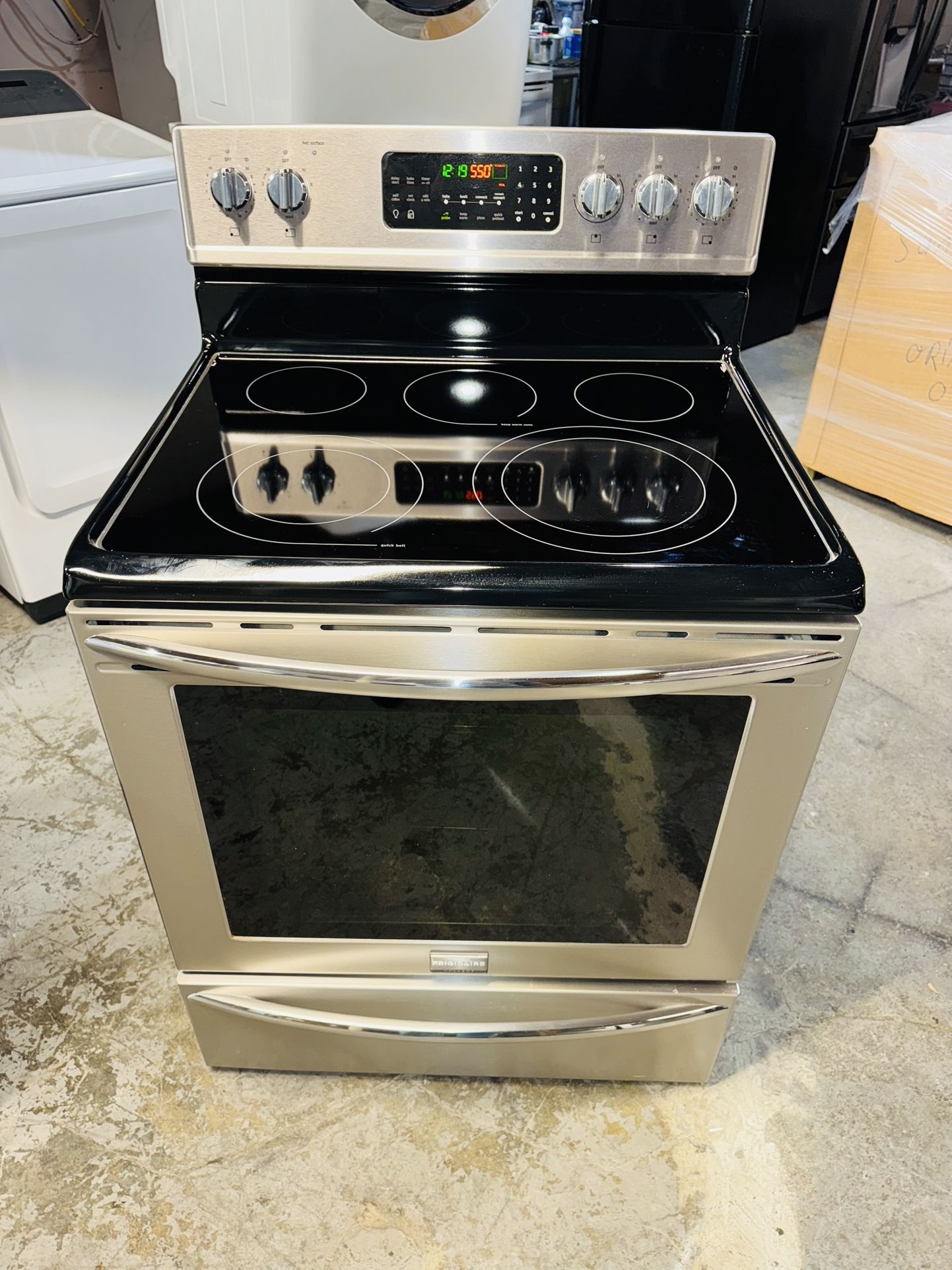 Frigidaire stainless steel electric stove with a receipt for a 90-day warranty