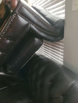 A black leather pouch and loveseat