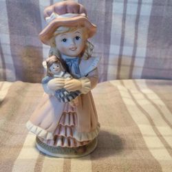 Girl Holding Doll Figurine