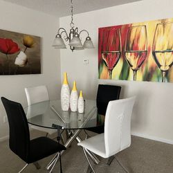 Round glass dining room table and four chairs