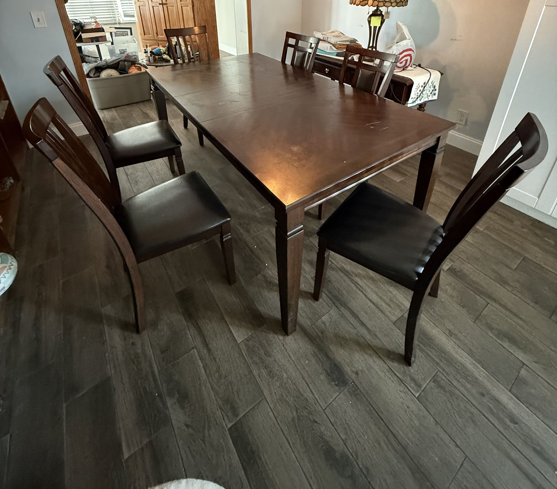 Brown Wood Dining Table And 6 Cushioned Chairs