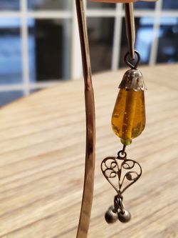 Dangling amber charm with beautiful silver colored ornate charm Use for book holder