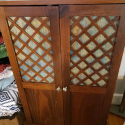 
Pier 1 Armoire

Lattice style front 
6 compartments 
2 shelves 
4 holes for cords 

 Dimensions: 
Width: 33 inches, Height: 55 inches, Depth: 21 inch