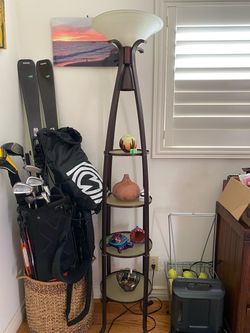 Tall floor lamp with glass round shelving.