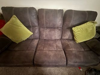 Two gray reclining sofas and two side tables with their two lamps included.