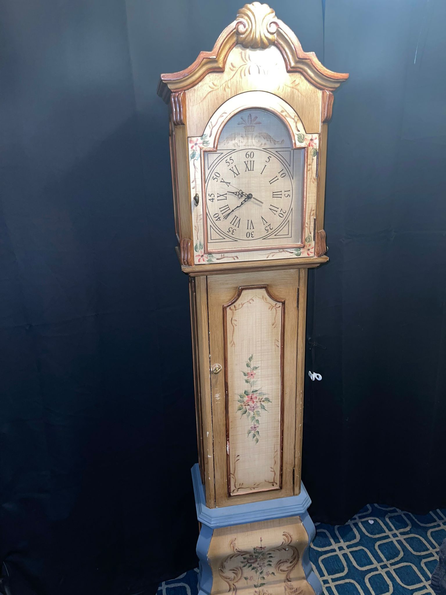 This is a custom hand painted and colored Pulaski model floor clock, a type of grandfather clock. The clock features a decorative floral design and a