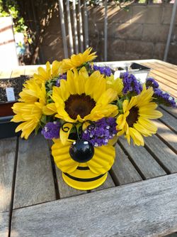 Sunflower arrangement in a metal bee bucket