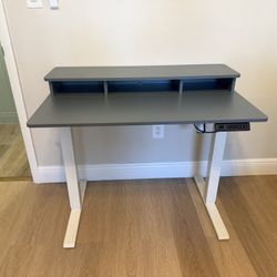 Office Desk- Blue and white with bag hooks standing desk but I don’t have the cable. Wheels included
