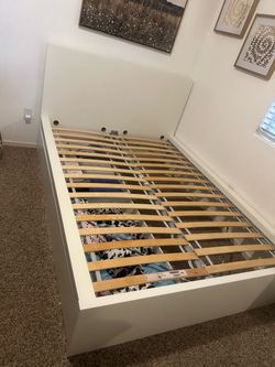 White IKEA MALM full size bed frame with slats and matching nightstand