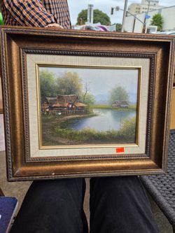 Traditional vintage-style oil painting depicting a river landscape with traditional houses or stilt houses of an Asian village.