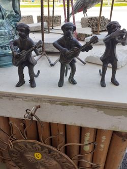 Little metal monkey statues playing musical instruments sold separately