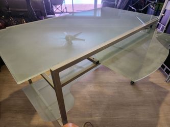 COMPUTER GLASS DESK WITH WHEELS AND A LEATHER CHAIR