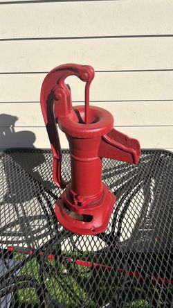 red cast iron hand-operated water pitcher pump