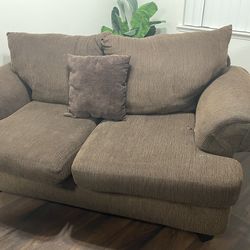 Brown love seat and sofa