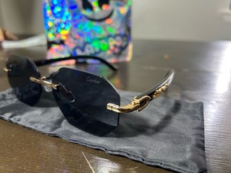 vintage-style rimless Cartier sunglasses with gold hardware and dark lenses