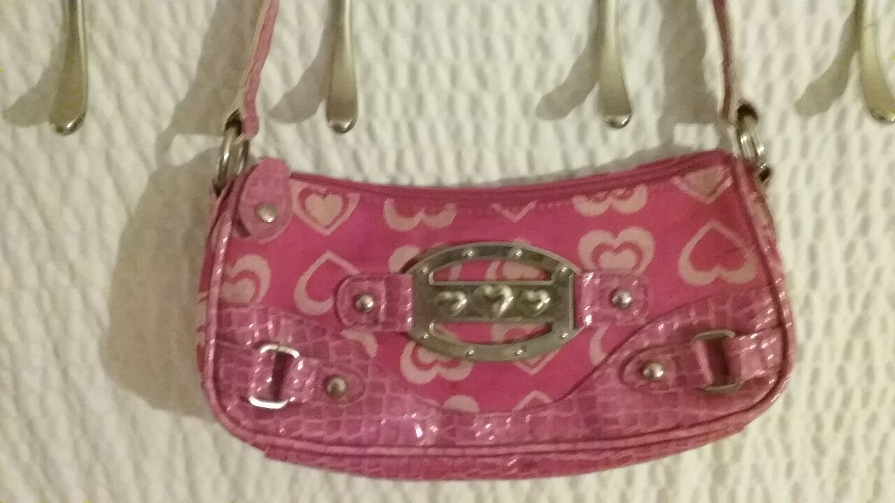 Small pink clutch handbag.