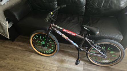 Selling bike good condition with stickers and wheel straws